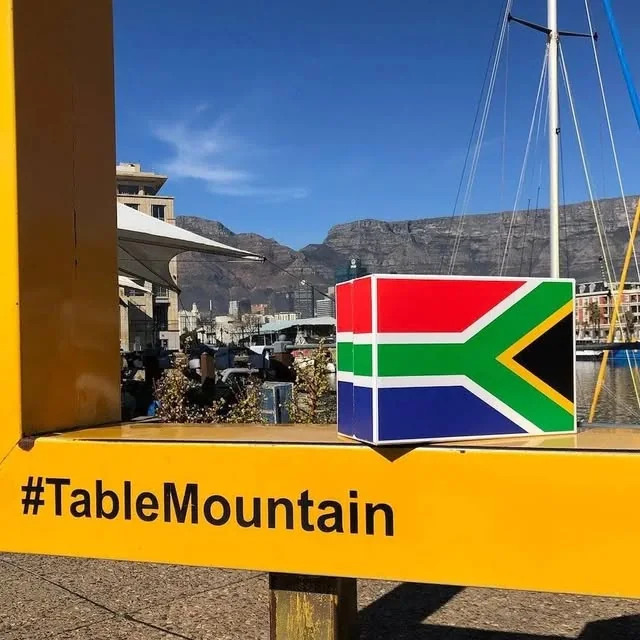 A South African flag wine box on the yellow frame at the V&A Waterfront, Table Mountain behind