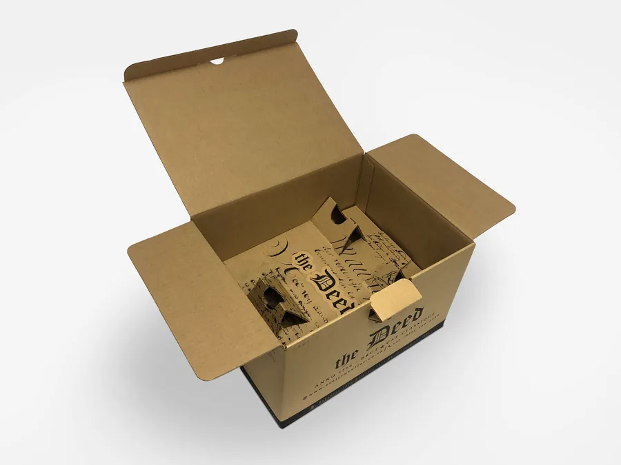 An open kraft carton for The Deed with a printed insert inside